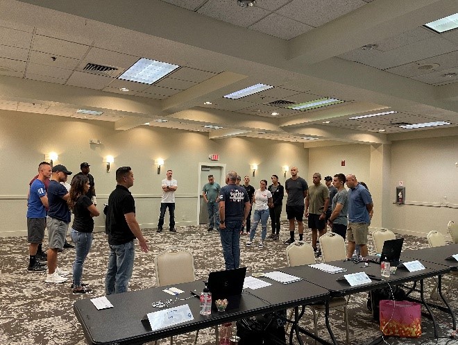 Attendees standing in a banquet hall for an exercise for a RTO Course in Folsom, CA